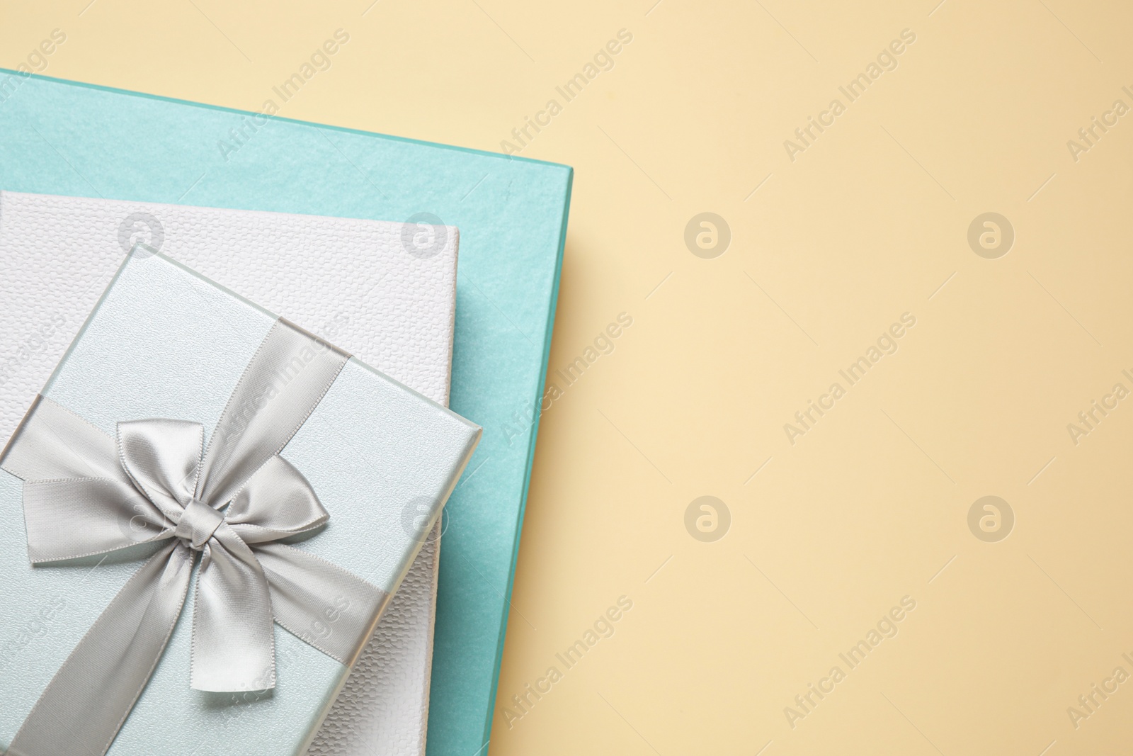 Photo of Beautiful gift boxes on beige background, top view. Space for text