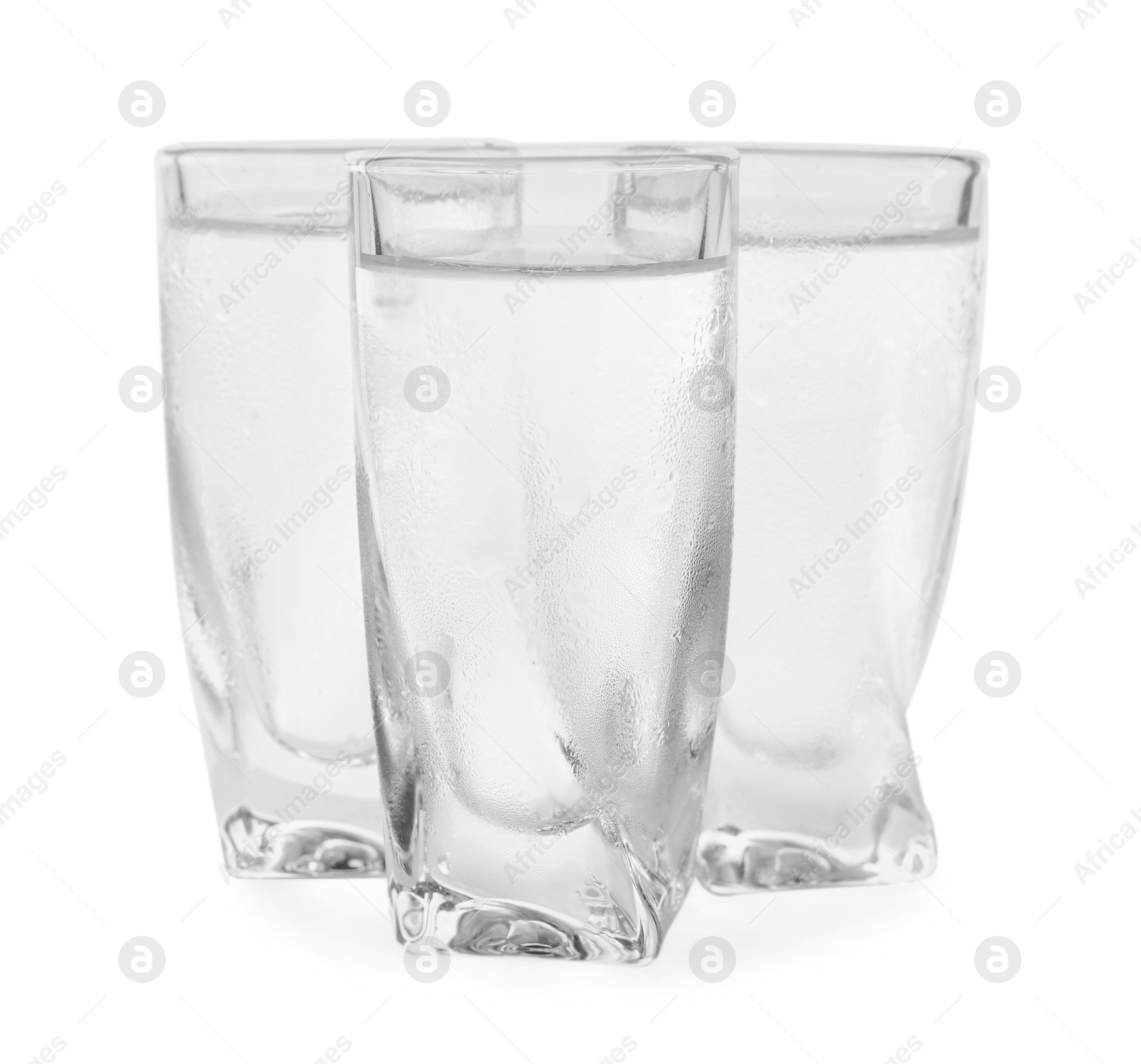 Photo of Vodka in shot glasses on white background