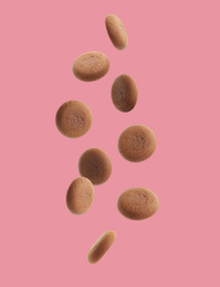 Set of falling delicious chocolate cookies on pink background