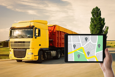 Image of Logistics concept. Man using tablet with map on screen against truck