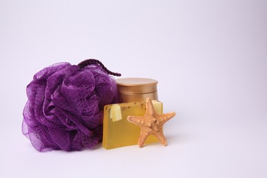 Photo of Purple shower puff, cosmetic products and starfish on white background
