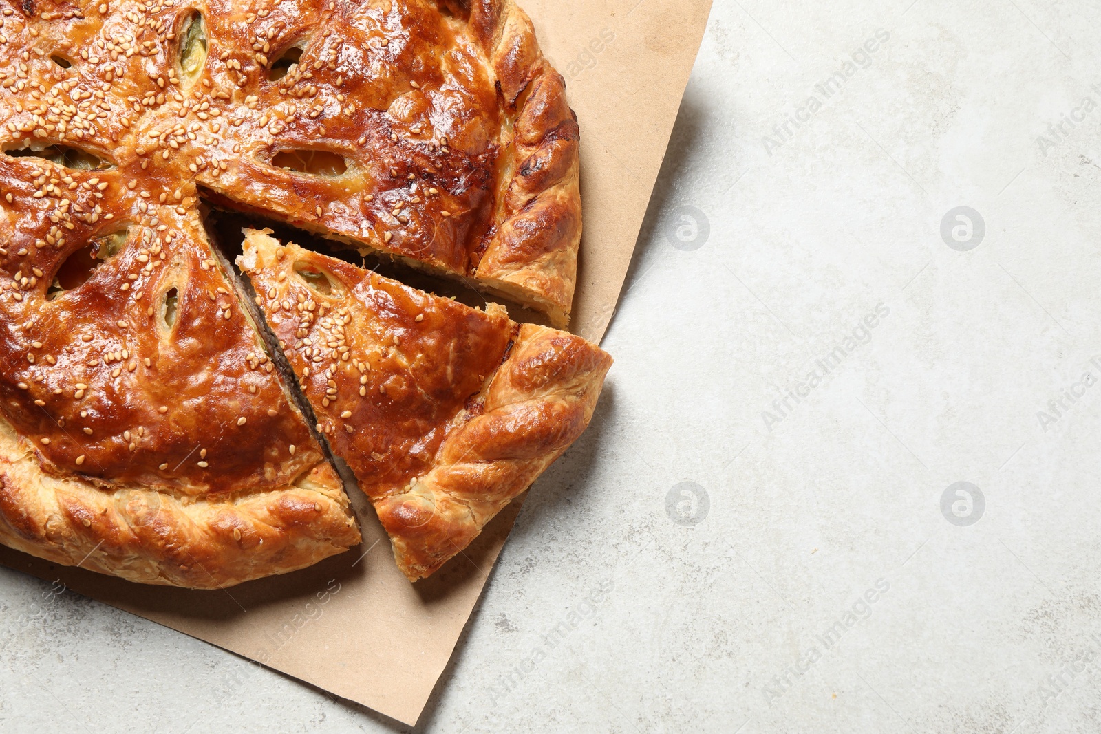 Photo of Cut delicious homemade pie on light grey table. Space for text