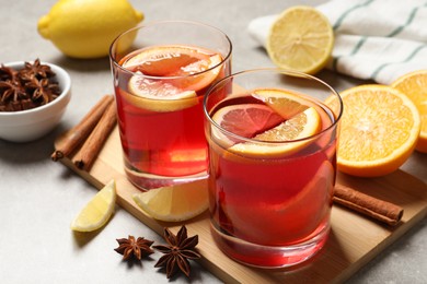 Aromatic punch drink and ingredients on light grey table