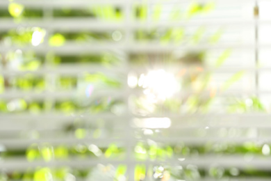 Photo of Blurred view through window on garden in morning