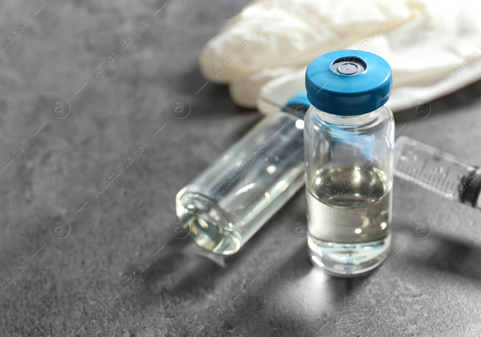 Photo of Vials and syringe with medicine on table. Vaccination concept