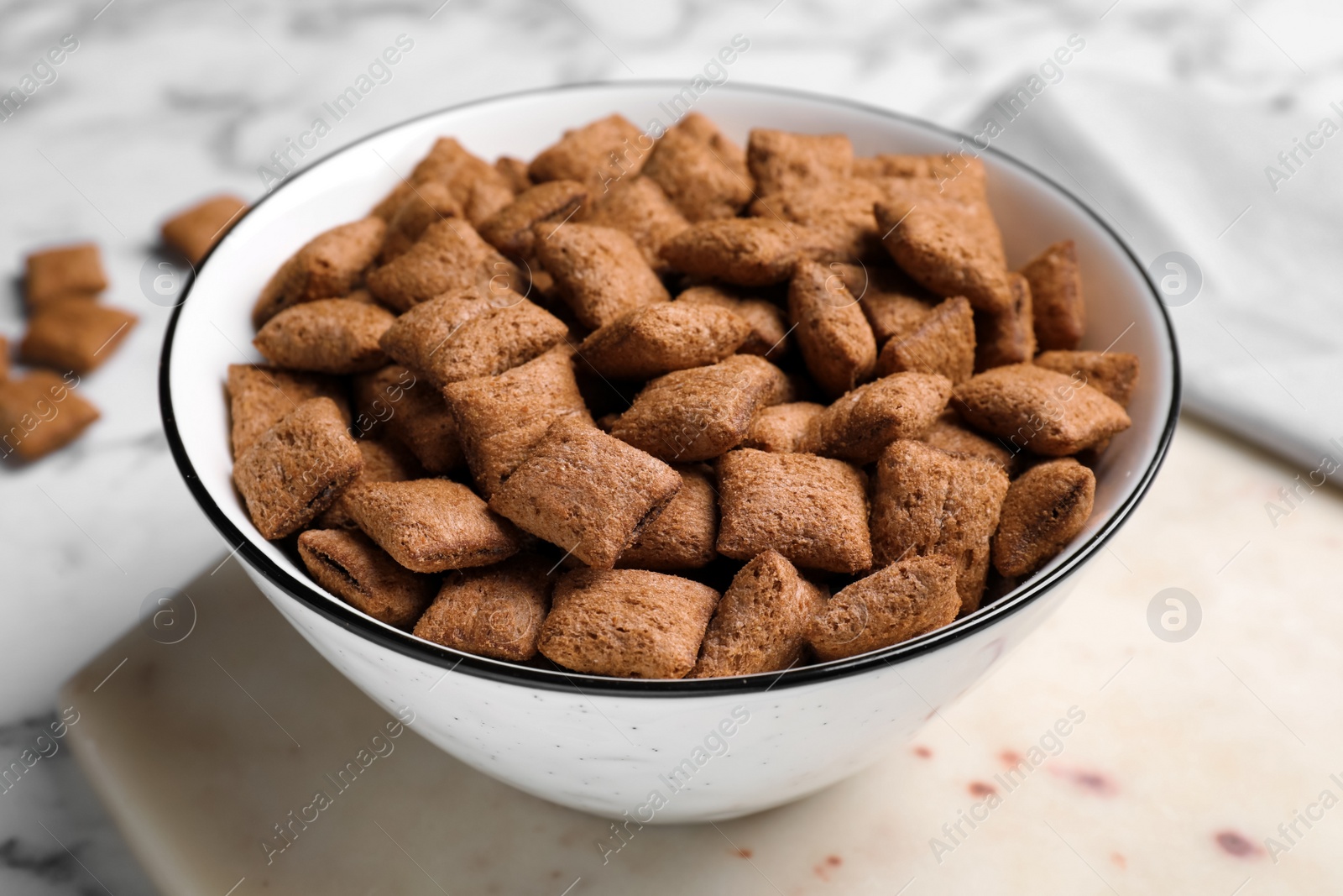 Photo of Delicious chocolate corn pads on white board, closeup