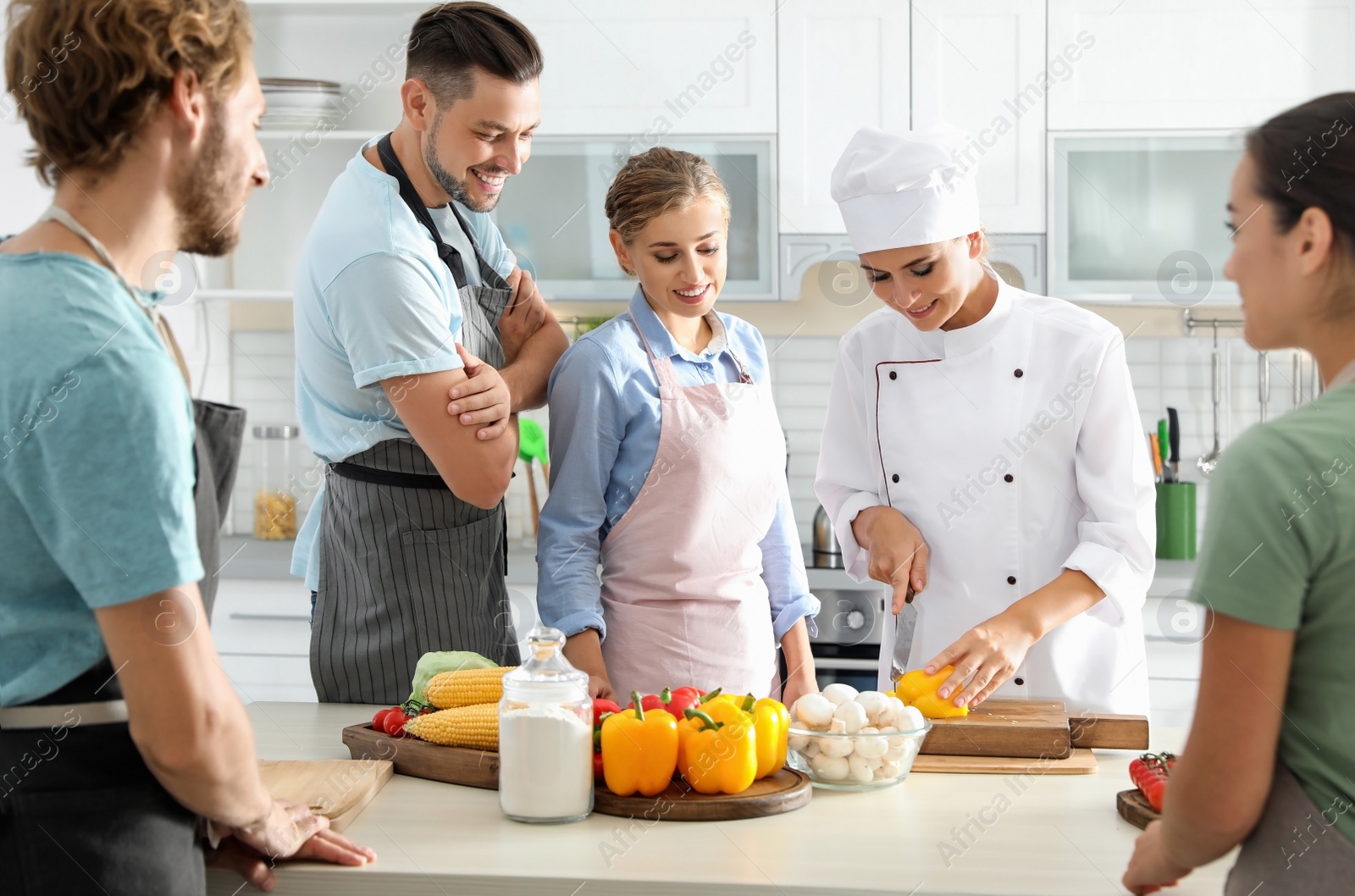 Photo of Group of people and female chef at cooking classes