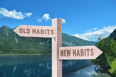 Image of Alcohol addiction: what to choose - life with old bad habits or new good ones? Wooden signpost with different directions against beautiful mountain landscape
