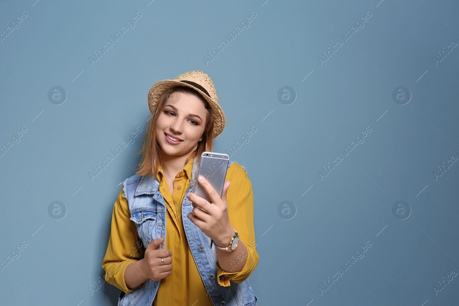 Photo of Attractive young woman taking selfie on color background