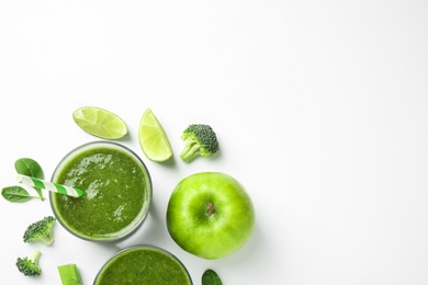 Delicious green juice and fresh ingredients on white background, flat lay. Space for text