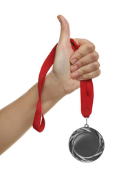 Photo of Woman holding silver medal on white background, closeup. Space for design