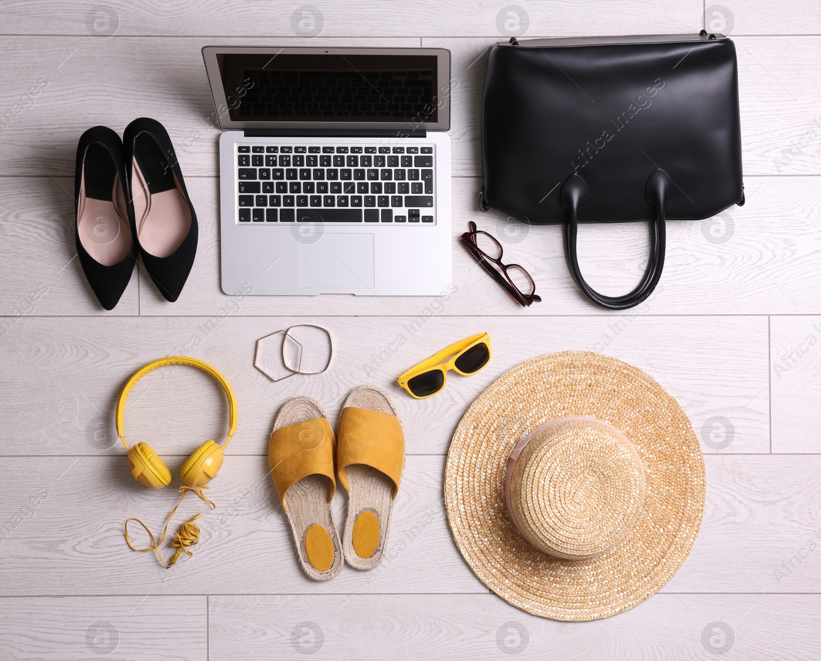 Photo of Flat lay composition with business supplies and beach accessories on white wooden floor. Concept of balance between work and life