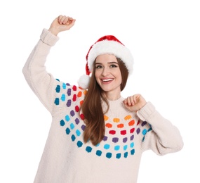 Photo of Happy young woman in sweater and Santa hat on white background. Christmas celebration