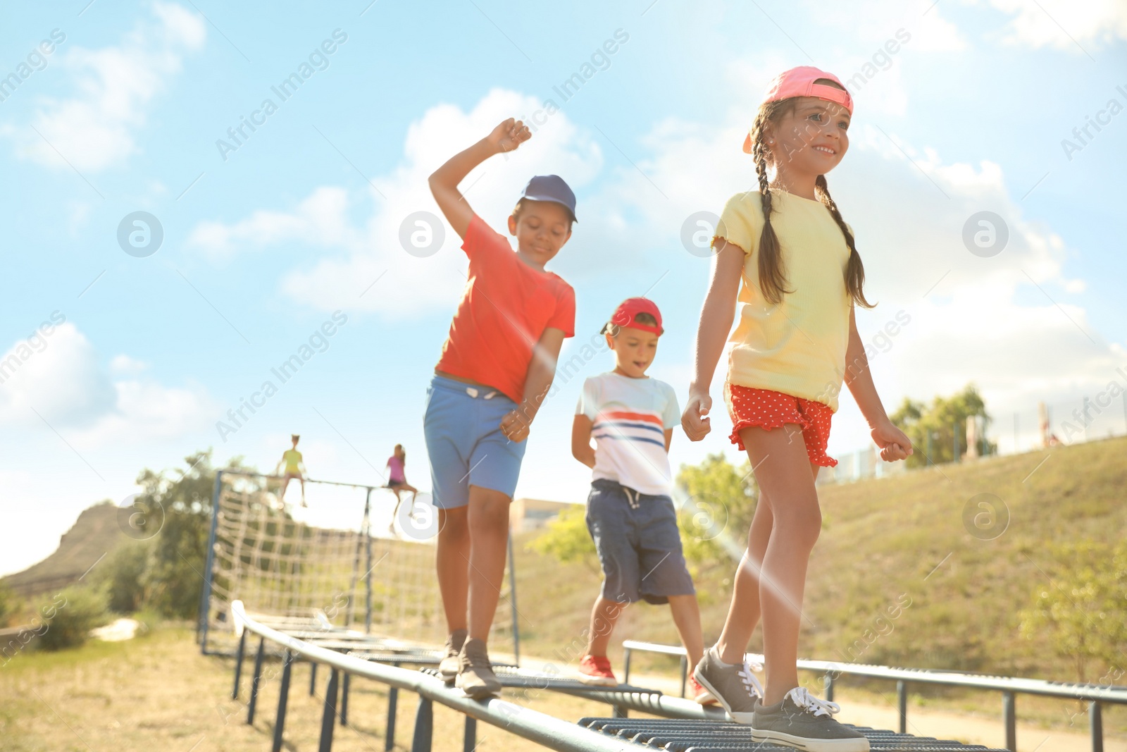 Photo of Cute children on playground climber outdoors. Summer camp