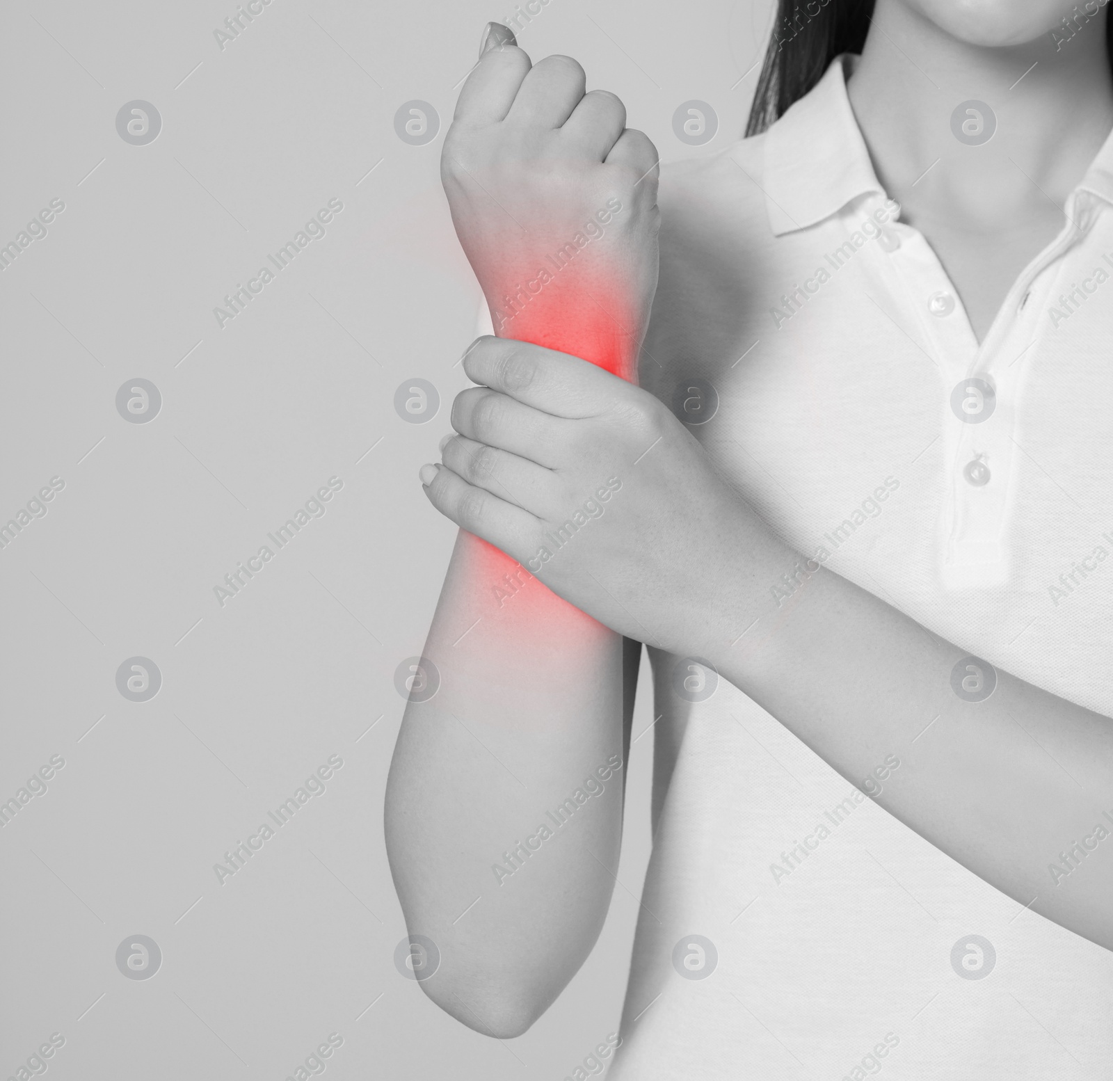 Image of Woman suffering from pain in wrist, closeup. Black and white effect