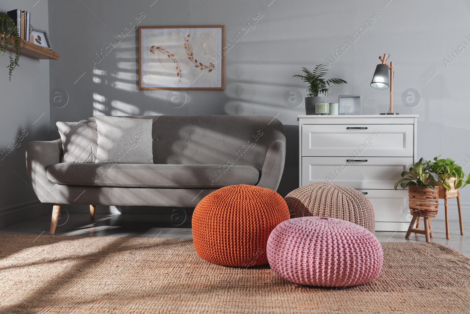 Photo of Stylish knitted poufs and sofa in living room. Home design