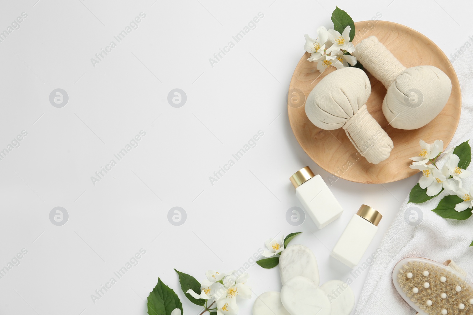 Photo of Flat lay composition with spa stones and jasmine flowers on white background, space for text