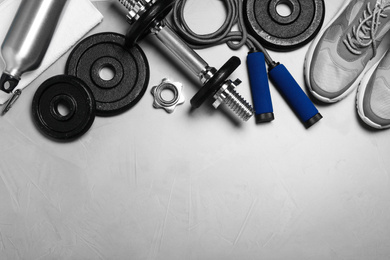 Photo of Gym equipment on light grey background, flat lay