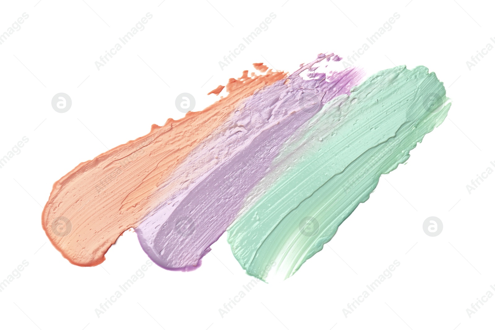 Photo of Strokes of pink, green and purple color correcting concealers isolated on white, top view