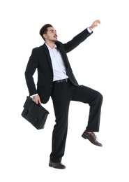 Photo of Young businessman attracted to magnet on white background