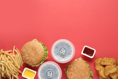 Photo of Flat lay composition with delicious fast food menu on red background. Space for text