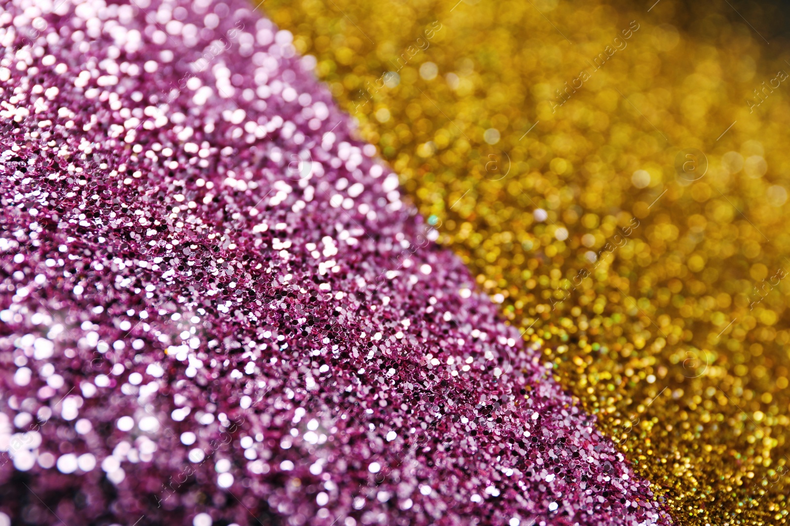 Photo of Gold and rose glitter as background, closeup