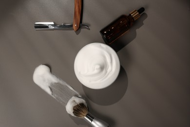 Photo of Set of men's shaving tools and foam on gray table, flat lay
