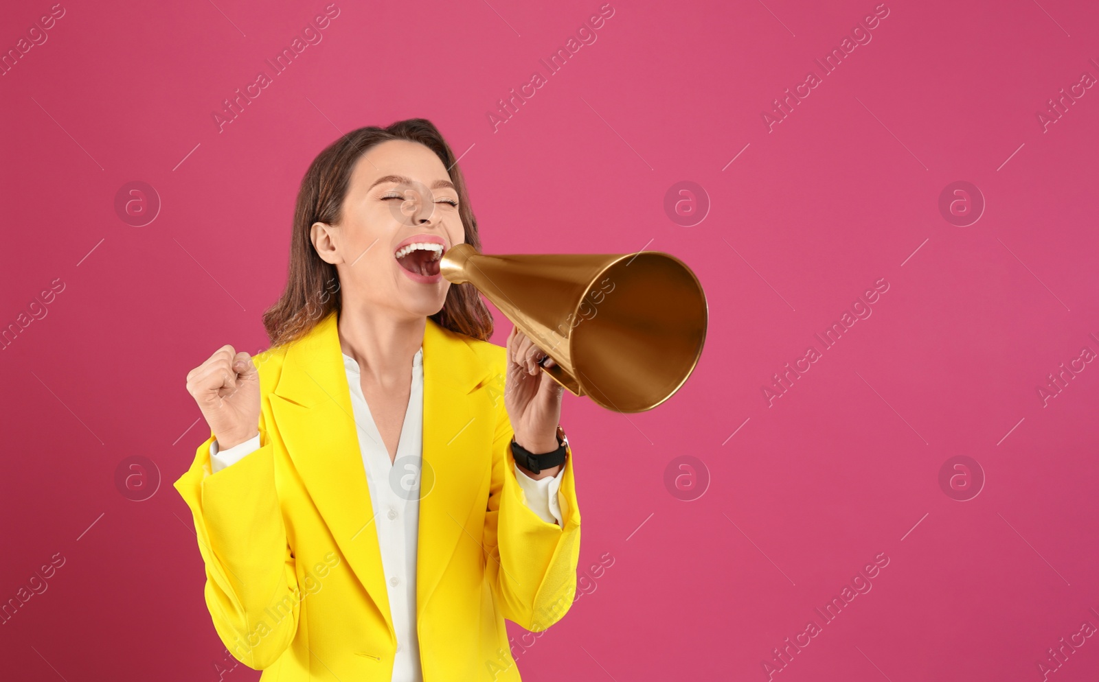 Photo of Young woman with megaphone on pink background