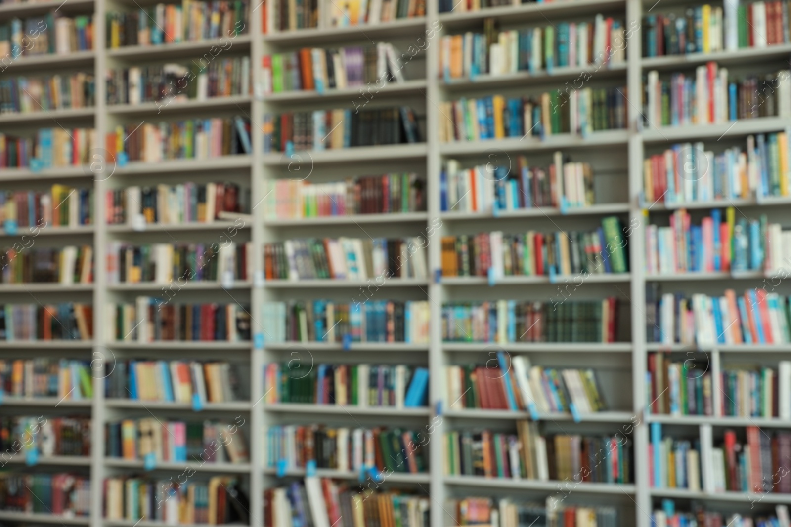 Photo of Blurred view of shelves with books in library