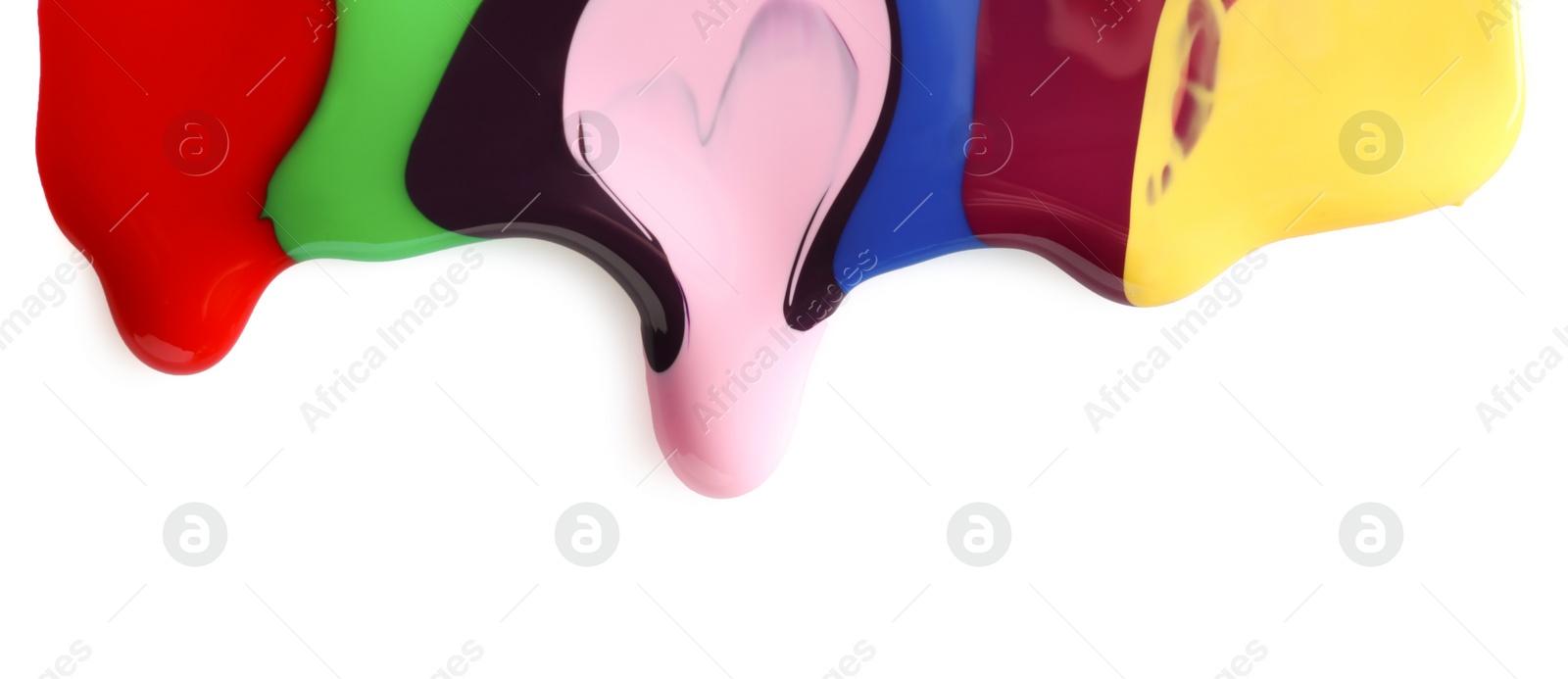 Photo of Mixed different color nail polishes flowing on white background