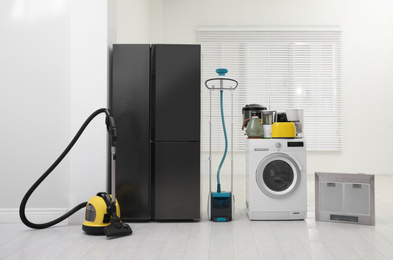 Photo of Refrigerator and different household appliances in room