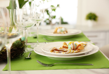 Beautiful festive Easter table setting with eggs