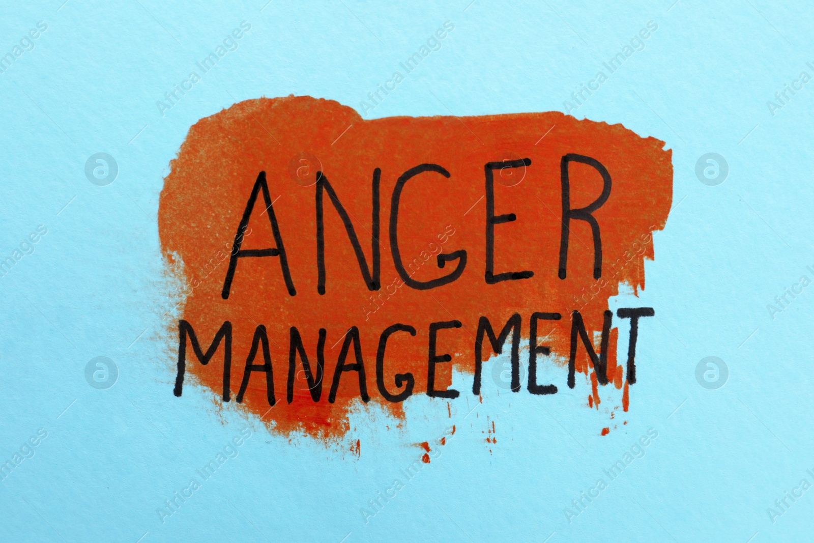 Photo of Phrase Anger Management written on light blue background with color paint