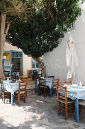 Beautiful outdoor cafe with wooden furniture on sunny day