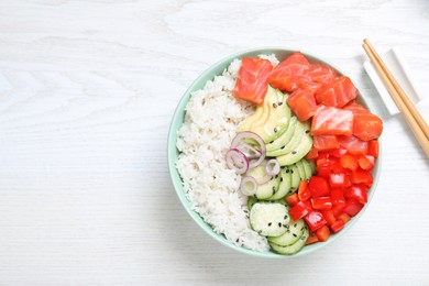 Photo of Delicious poke bowl with salmon and vegetables served on white wooden table, flat lay. Space for text