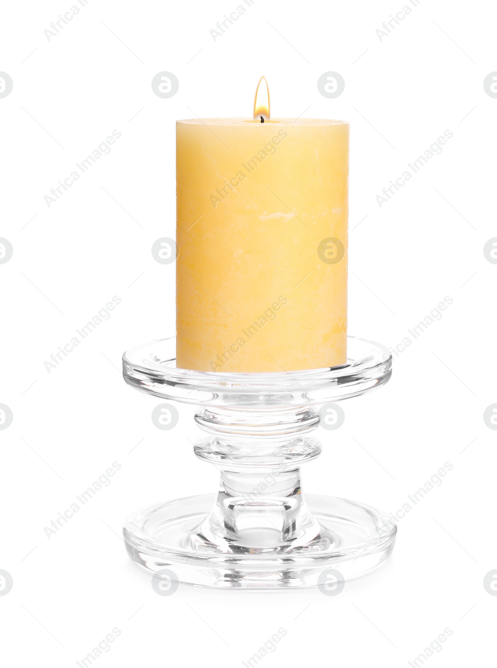 Photo of Burning yellow wax candle isolated on white