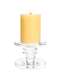 Photo of Burning yellow wax candle isolated on white