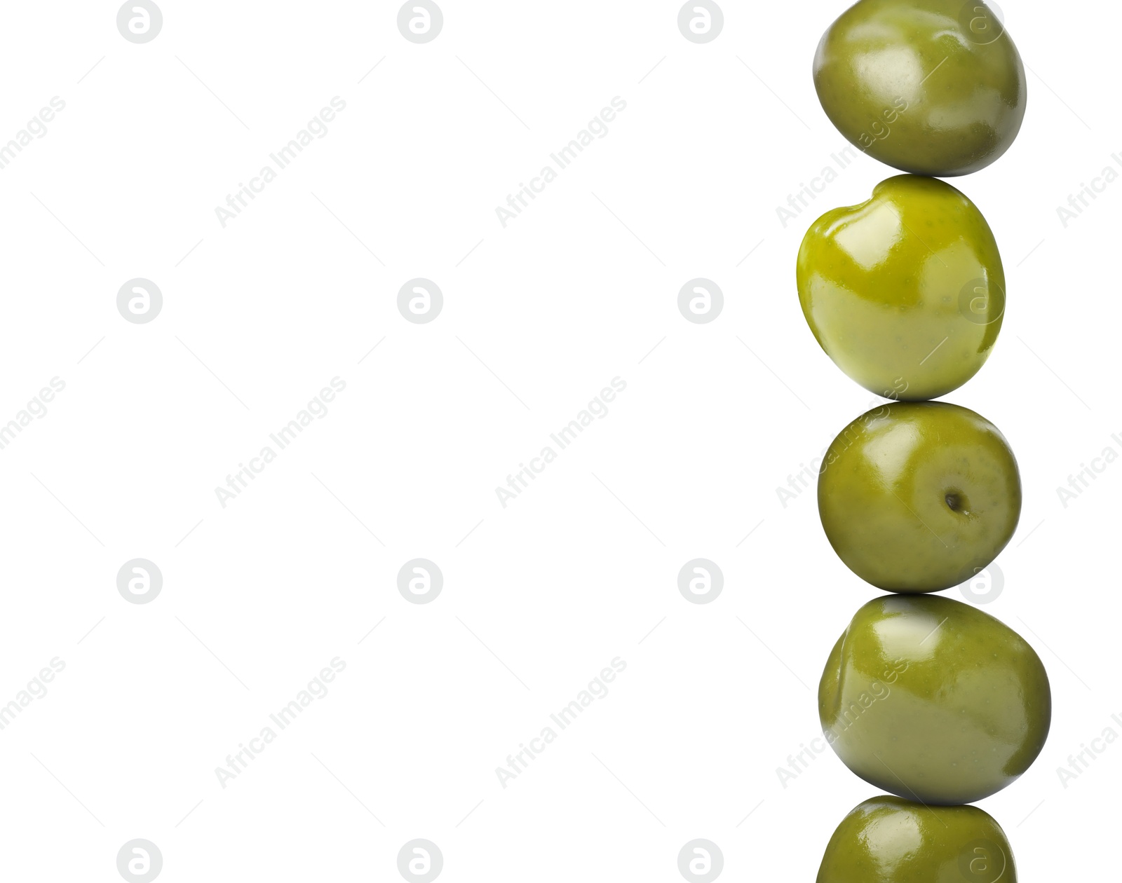 Image of Stack of whole olives on white background