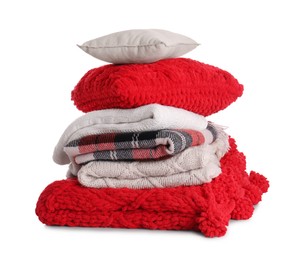 Photo of Stack of pillows and folded warm plaids on white background