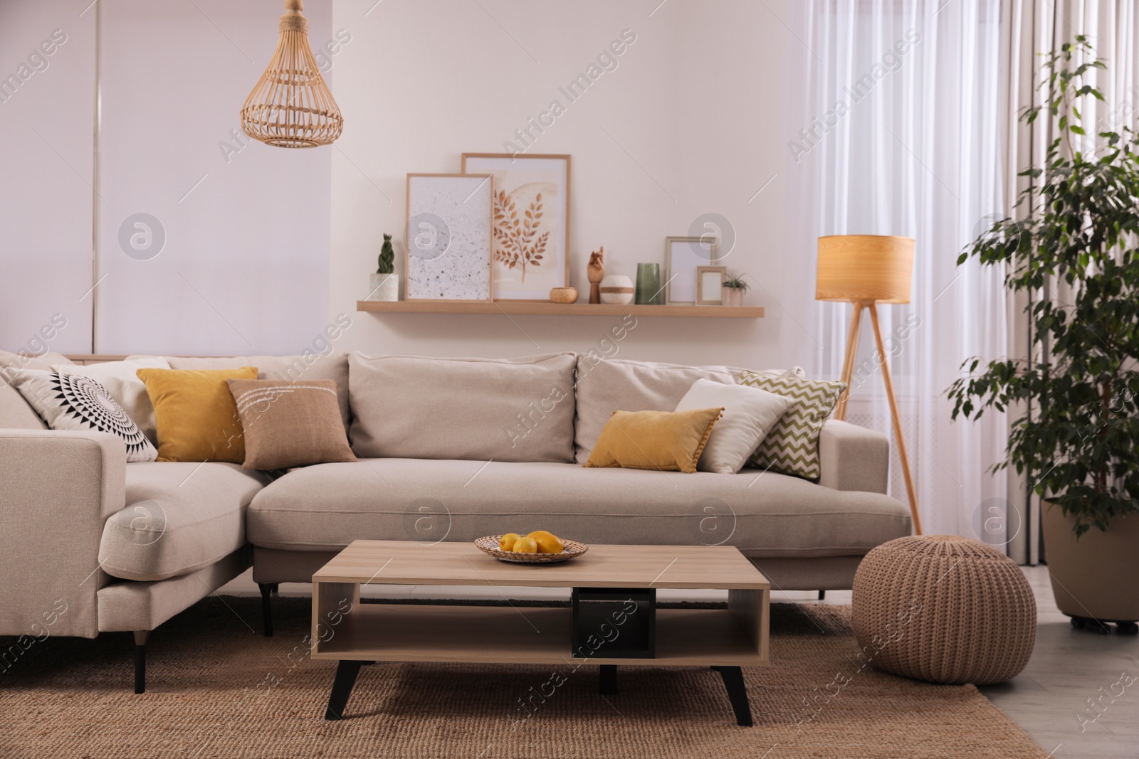 Photo of Stylish living room interior with comfortable grey sofa and coffee table