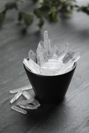 Photo of Menthol crystals in bowl on grey background