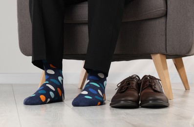 Photo of Man wearing colorful socks indoors, closeup view