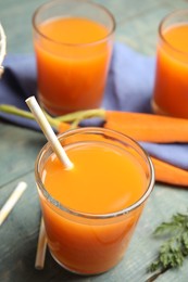 Freshly made carrot juice on wooden table