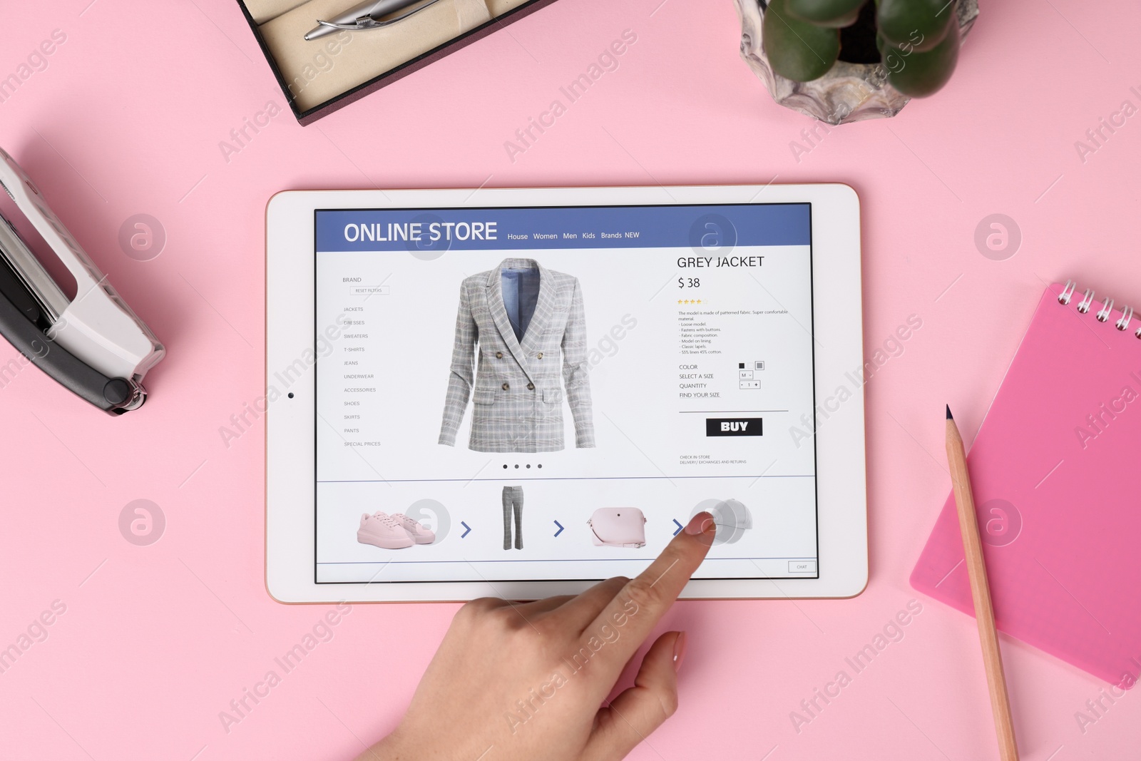 Photo of Woman with tablet shopping online on pink background, top view