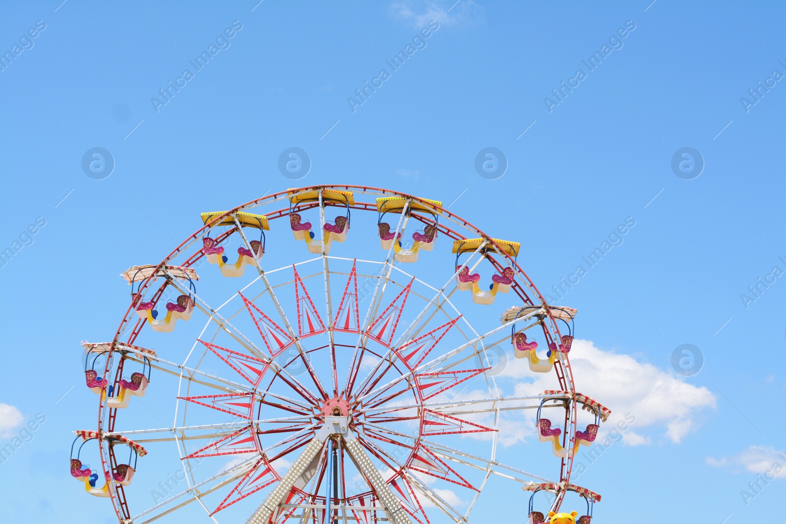 Photo of Large empty observation wheel against blue sky