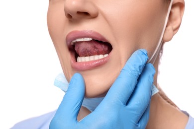Photo of Doctor examining woman`s oral cavity on white background, closeup