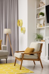 Spring atmosphere. Comfy armchair, lamp and shelves in stylish room