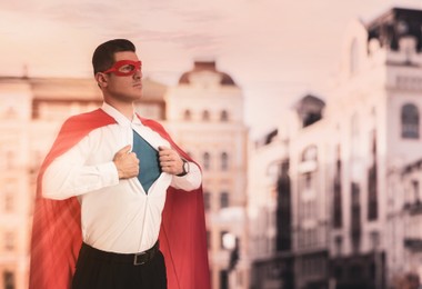 Image of Businessman in superhero cape and mask taking shirt off  against beautiful cityscape  