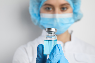 Doctor holding vial with medication, closeup. Vaccination and immunization