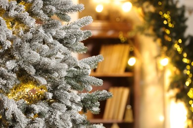 Beautiful decorated Christmas tree with festive lights on blurred background, closeup. Space for text